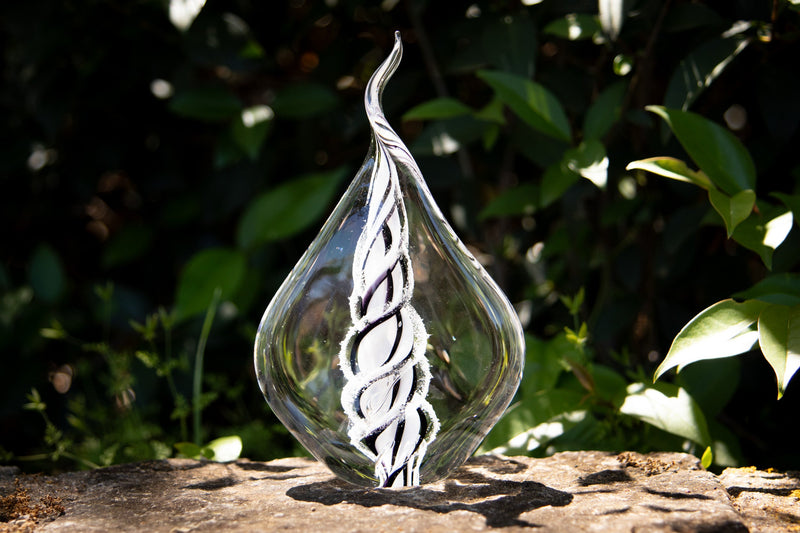 glass flame with cremation ash from pets and people